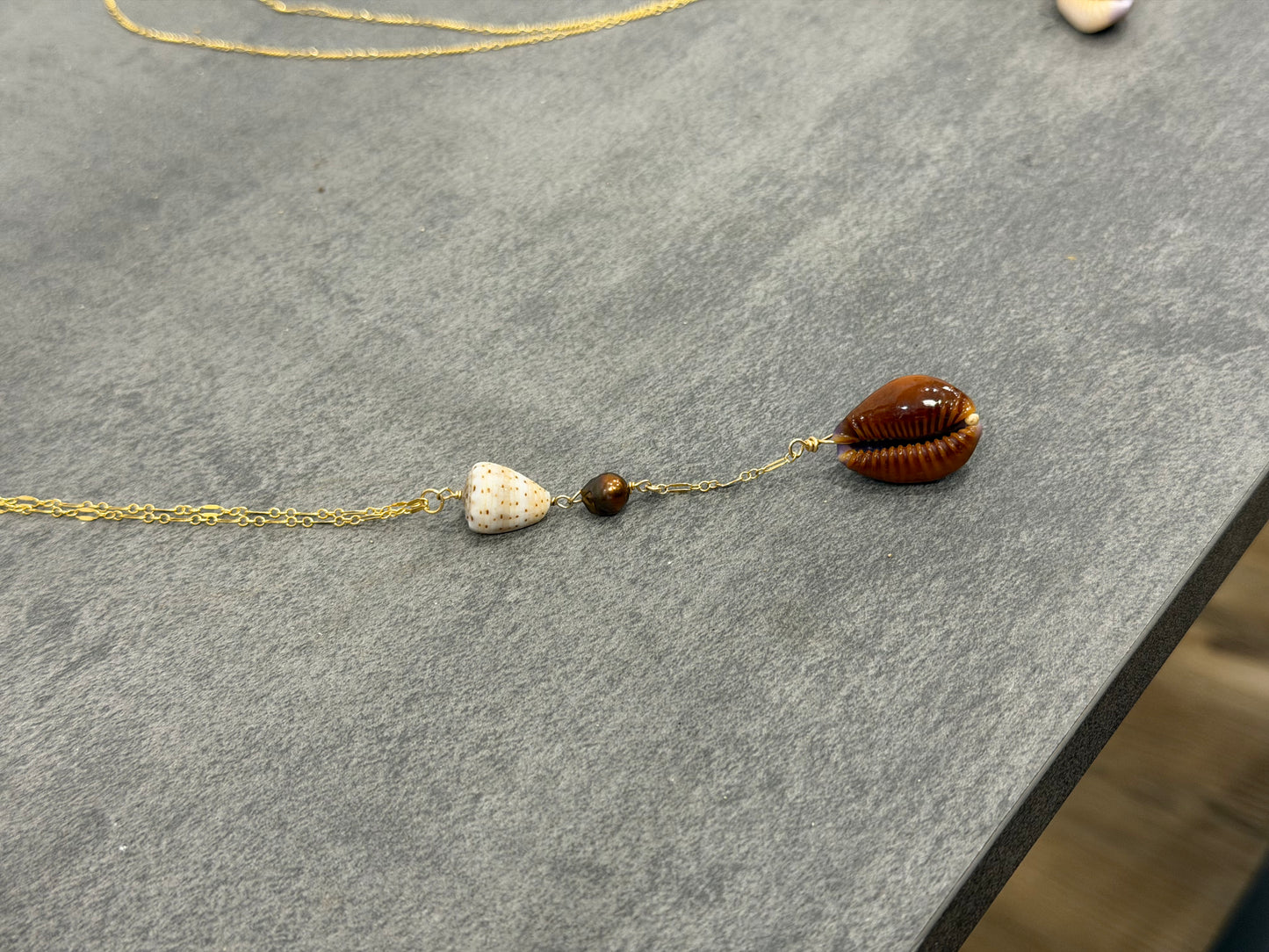 Dark cowrie drop necklace